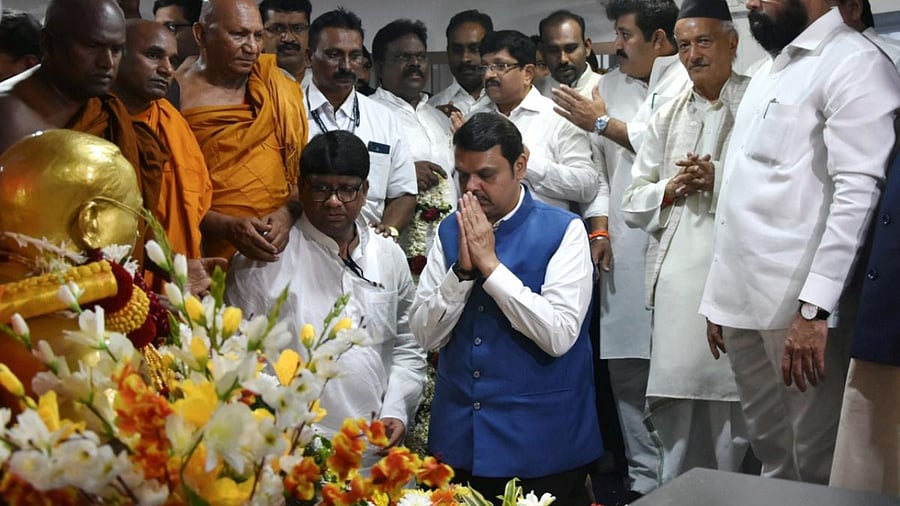 Maharashtra Deputy Chief Minister Devendra Fadnavis pays homage to Babasaheb B.R. Ambedkar on his death anniversary as Governor Bhagat Singh Koshyari and Chief Minister Eknath Shinde look on. Credit: PTI Photo