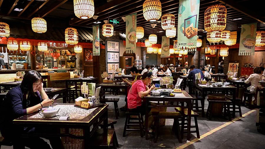 People dine at a restaurant in Beijing. Credit: AFP File Photo