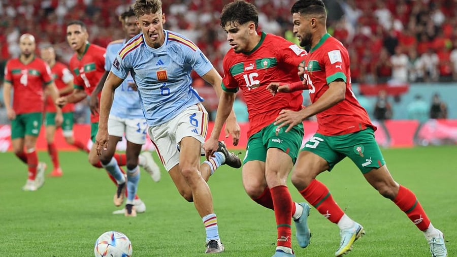 Spain's midfielder #06 Marcos Llorente (C) fights for the ball with Morocco's forward #16 Abde Ezzalzouli (2nd R) and Morocco's defender #25 Yahya Attiyallah during the Qatar 2022 World Cup. Credit: AFP Photo