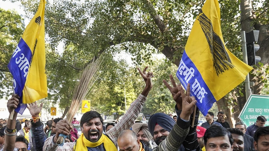 AAP supporters celebrate Delhi MCD election results outside a counting centre in New Delhi on Wednesday. Credit: PTI Photo