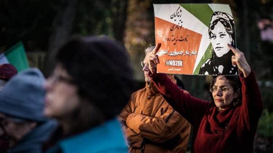 A protestor holds a slogan which reads in Persian as 'No to Islamic Republic'. Credit: AFP Photo 