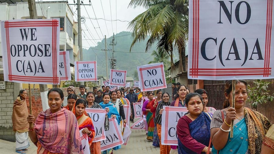 Women hold placards as they march during a demonstration against the Citizenship Amendment Act (CAA) in Guwahati, Saturday, December 21, 2019. Credit: PTI Photo