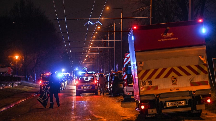 Policemen guard a security perimeter as firefighters and rescuers work in a building of the Mas-Du-Taureau quarter where a fire caused many victims, including children, in Vaulx-en-Velin, east of Lyon, south-eastern France, on December 16, 2022. Credit: AFP Photo