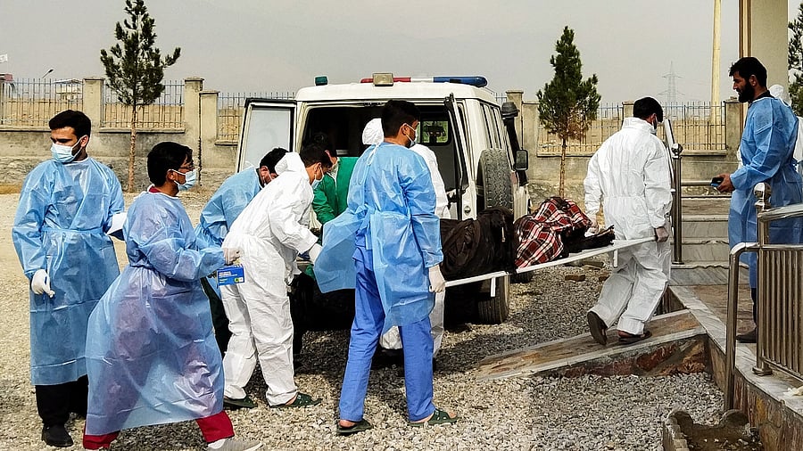 Afghan medical staff carry the bodies of the victims who lost their lives after an oil tanker caught fire a night before at Salang pass tunnel in Charikar city. Credit: AFP Photo
