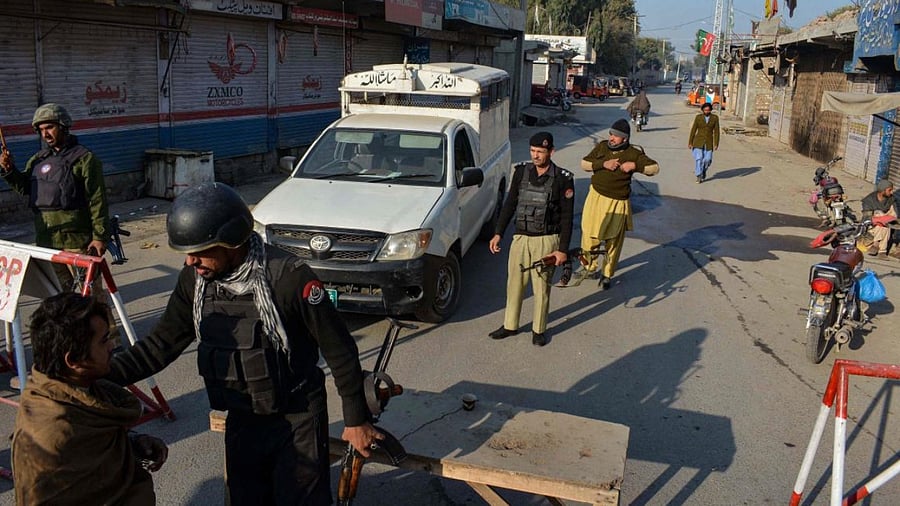 Police stand guard along a road they blocked after Taliban militants seized a police station in Bannu. Credit: AFP Photo