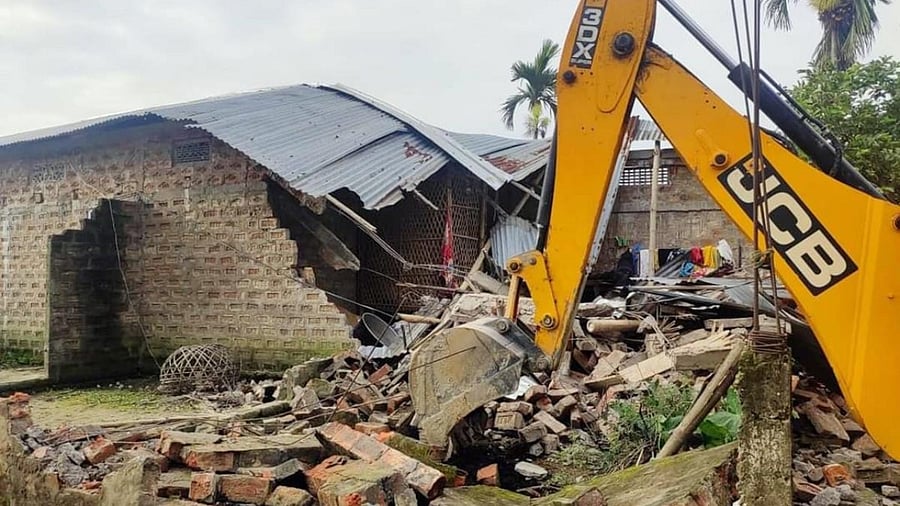 An earthmover during an eviction drive in Nagaon. Representative Image. Credit: PTI Photo