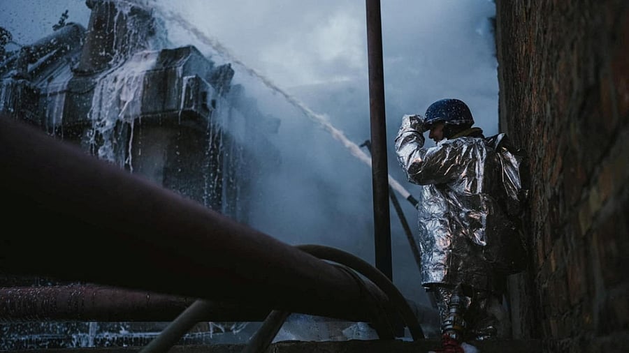A firefighter works at a site of a critical power infrastructure object, which was hit during Russia's drones attacks in Kyiv, Ukraine, in this handout picture released December 19, 2022. Credit: Reuters Photo