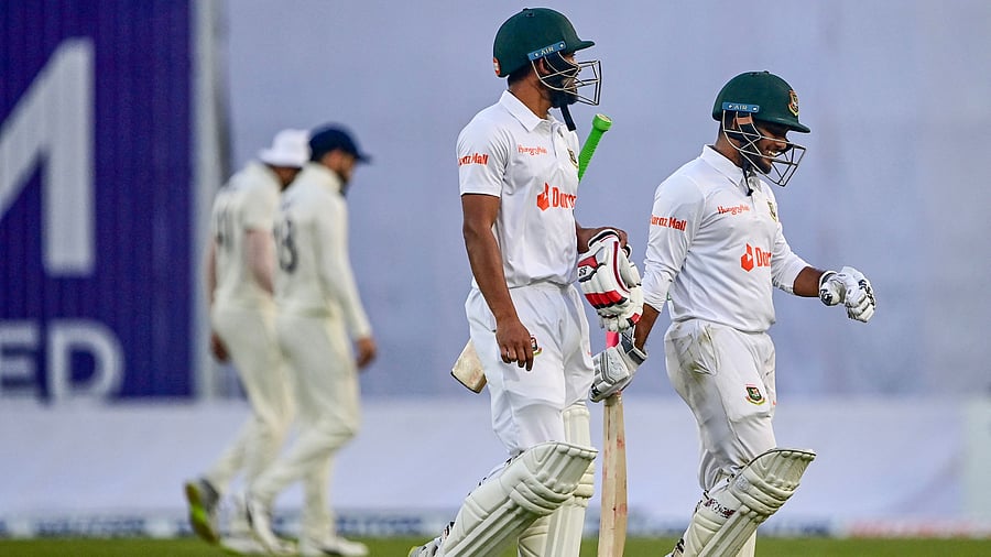 Nazmul Hasan Santo (L) and Zakir Hasan (R) walk off the field after the second day. Credit: AFP Photo