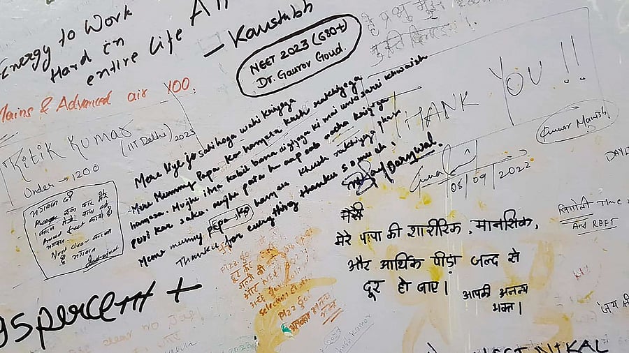 Wishes scribbled by JEE, NEET coaching students on ‘wall of beliefs’ at Radha Krishna Temple in Kota. Credit: PTI Photo