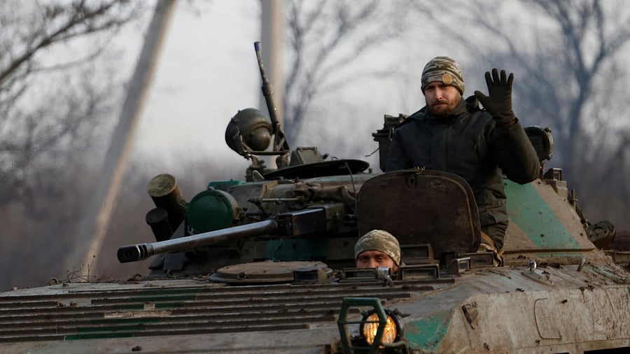 A Ukrainian serviceman waves from a tank, as Russia's attack on Ukraine continues. Credit: Reuters