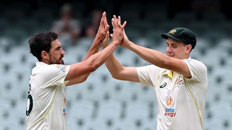 Australian bowler Mitchell Starc (L) and Cameron Green (R). Credit: AFP Photo