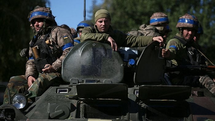 Ukrainian soldiers sit on a armoured personnel carrier (APC) on their way to the frontline against Russian troops in the Donetsk region. Credit: AFP Photo