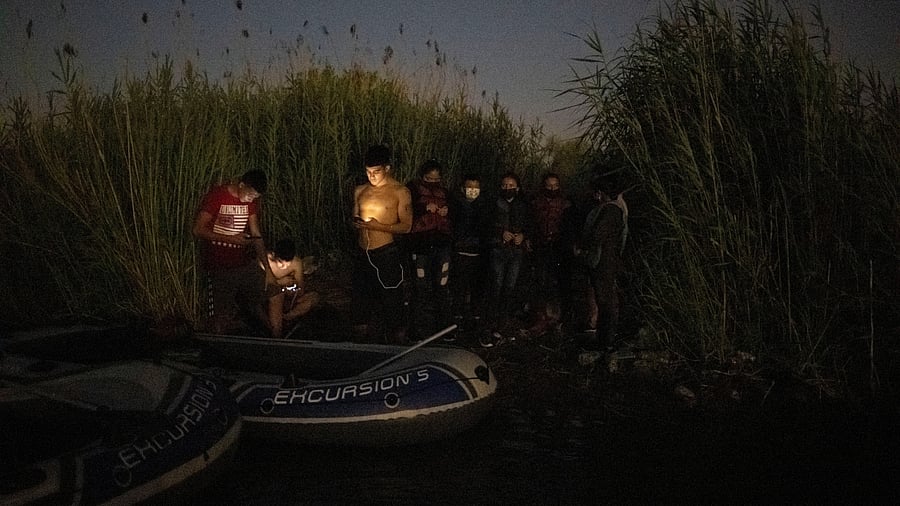 Smugglers wait with migrants near Rio Grande river in Mexico to cross over to the US. Credit: Reuters Photo