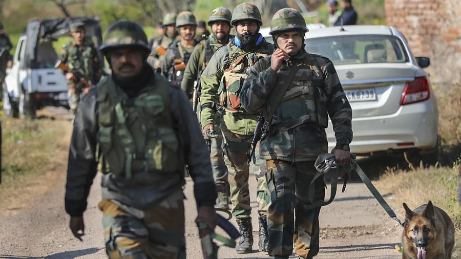 Army personnel with a sniffer dog conduct searches near the house where an IED explosion took place, at Dangri village in Rajouri district. Credit: PTI Photo