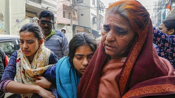 Anshika, sister of the 20-year-old woman Anjali Singh who was killed after being hit and dragged by a car, being taken away after she fainted during a visit by Deputy CM Manish Sisodia at her residence, at Sultanpuri in New Delhi. Credit: PTI Photo