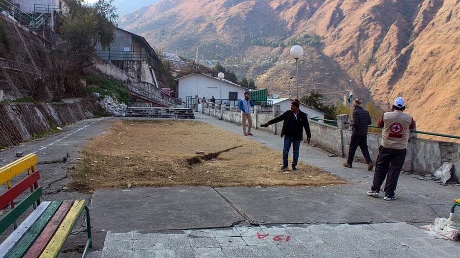 Cracks appear on the road due to landslides at Vishnupuram Marwari Colony, in the Joshimath of Uttarakhand. Credit: PTI Photo