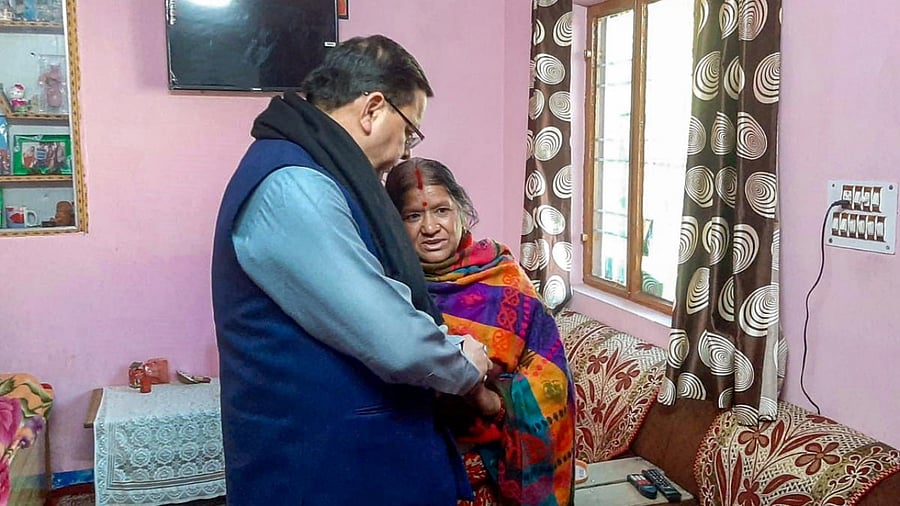 Uttarakhand Chief Minister Pushkar Singh Dhami interacts with a resident while inspecting the landslide affected area of Joshimath. Credit: PTI Photo