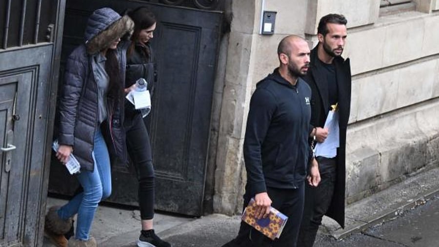 Andrew Tate (3rd L) and Tristan Tate (R) together with two Romanian complices women (L and 2nd L) exit a court in Bucharest, Romania. Credit: AFP Photo