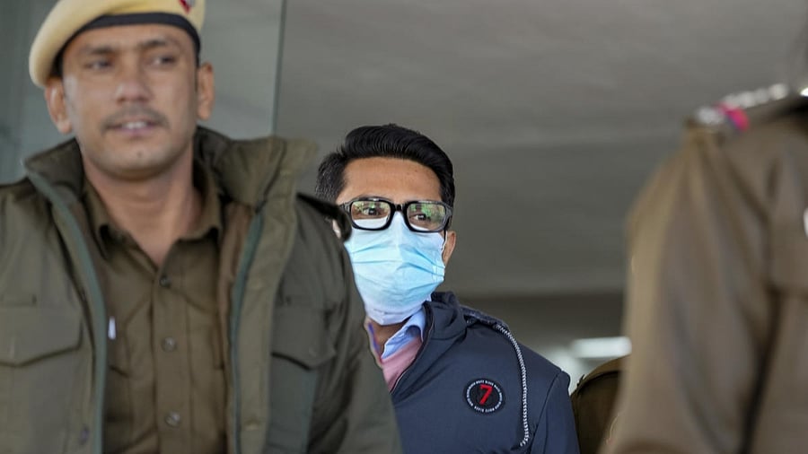 Shankar Mishra, accused of urinating on a woman passenger on an Air India flight from New York to Delhi, being taken away by the police from the DCP office at IGI Airport in New Delhi, Saturday, Jan. 7, 2023. Credit: PTI Photo