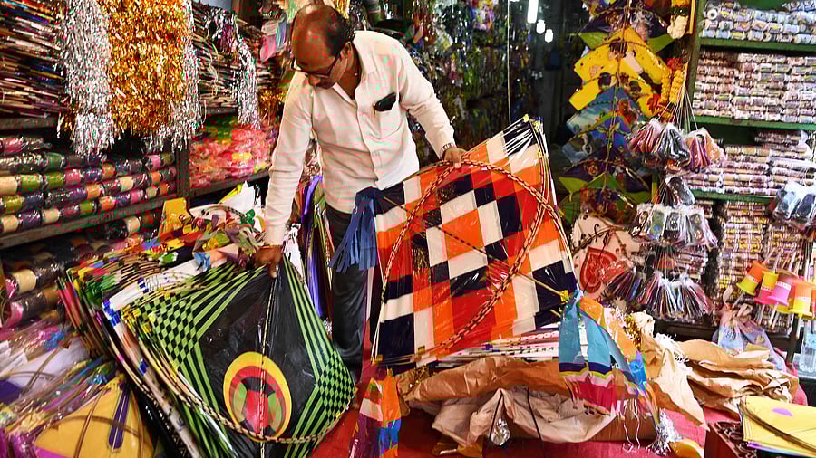A vendor arranges kites at a shop ahead of 'Makar Sankranti' kite festival in Hyderabad on January 3, 2023. Credit: AFP Photo