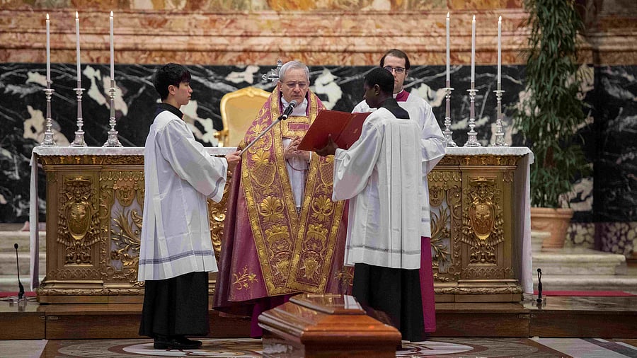 A priest prays during the funeral of Cardinal George Pell in St. Peter's Basilica at the Vatican. Credit: Reuters Photo