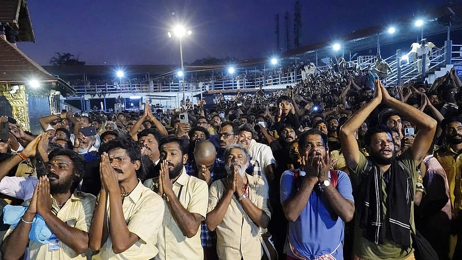 Devotees of Lord Ayyappa during the 'makrajyothi' at Sabarimala, in Pathanamthitta, Saturday. Credit: PTI Photo