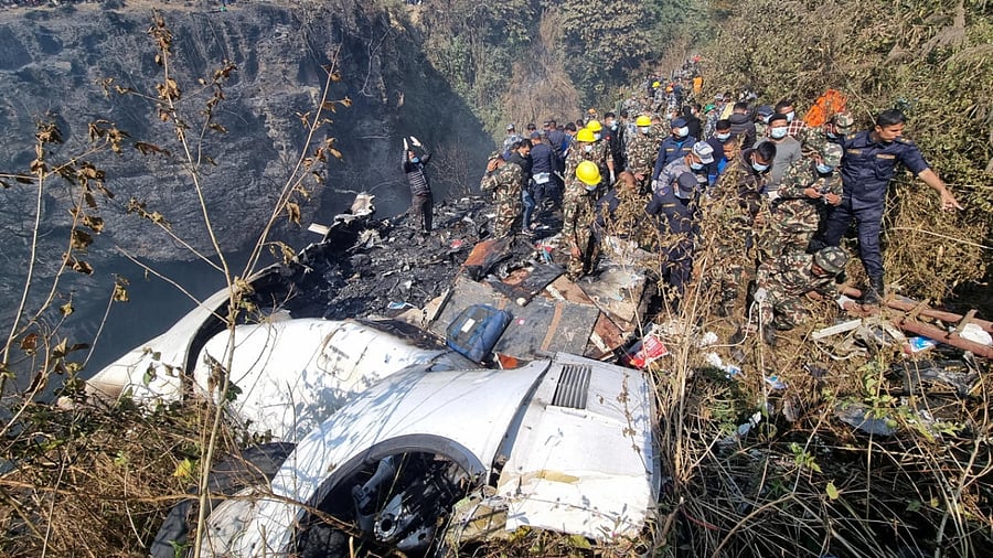 Rescue teams work to retrieve bodies at the crash site. Credit: Reuters Photo