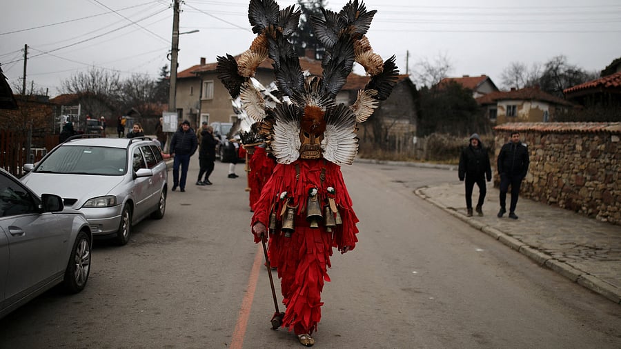 A person wearing mask made of feathers participates in a winter festival in the village of Kosharevo, Bulgaria. Credit: Reuters Photo