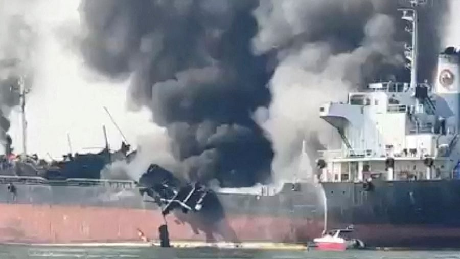 Smoke plums raise from 'SMOOTH SEA 22' an oil tanker that caught fire in Samut Songkhram, Thailand January 17, 2023, in this screen grab obtained from a social media video. Credit: Facebook/via Reuters