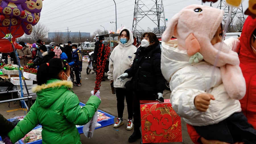 Customers shop ahead of the Chinese Lunar New Year at an outdoor market in Beijing, China. Credit: Reuters photo