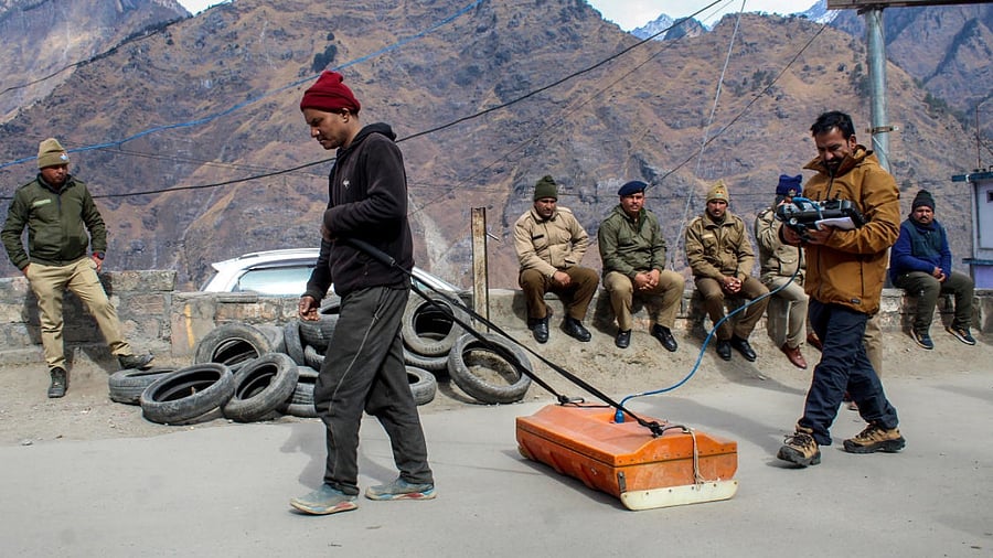 National Geophysical Research Institute (NGRI) team members check the bearing capacity of soil at the land subsidence-affected area in Joshimath. Credit: PTI Photo
