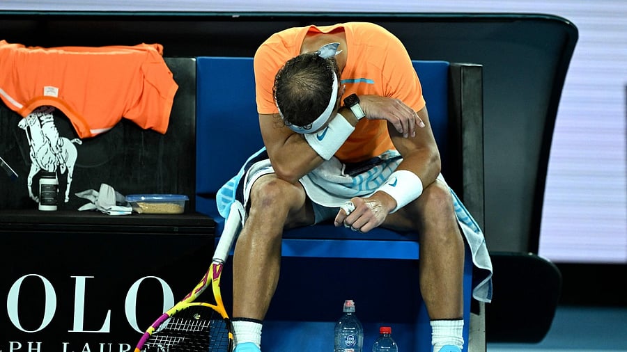 Rafael Nadal takes rest during the break in his men's singles match against Mackenzie McDonald of the US on day three of the Australian Open tennis tournament in Melbourne on January 18, 2023. Credit: AFP Photo