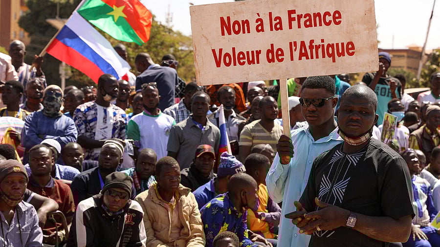 People hold a sign as they gather to show their support to Burkina Faso's new military leader Ibrahim Traore. Credit: Reuters Photo