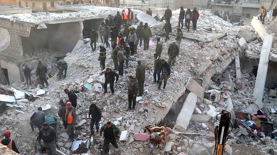 In this photo provided by Kurdish-run Hawar News Agency, civil defense workers and civilians work on the rubble of a destroyed building in the Sheikh Maksoud neighborhood in Aleppo. Credit: Hawar News Agency via AP/PTI