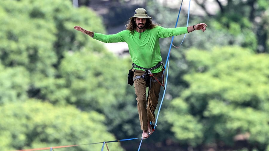 Brazilian highliner Rafael Bridi performs on a slackline 114 meters high and 510 meters long, crossing the entire Vale do Anhangabau, as part of the 469th anniversary of the city of Sao Paulo, Brazil on January 25, 2023. Credit: AFP Photo