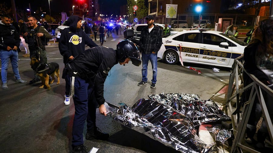 Israeli forces work at the scene of a shooting attack in Neve Yaacov. Credit: Reuters Photo
