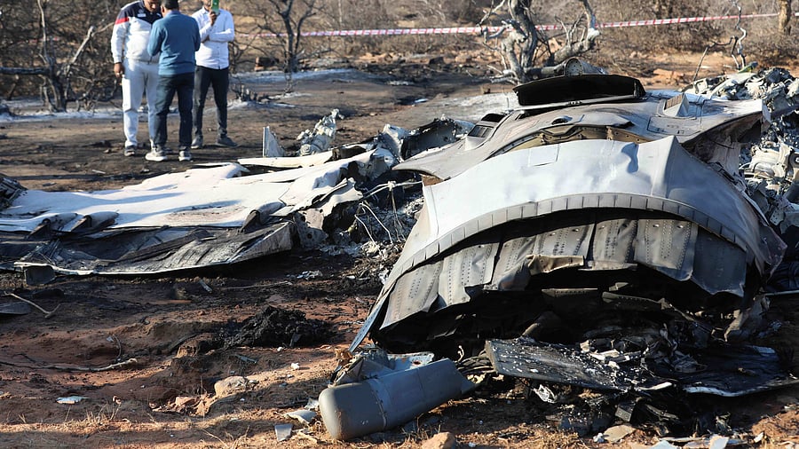 People stand next to a plane wreckage after a Sukhoi Su-30 and a Dassault Mirage 2000 fighter jets crashed during an exercise in Pahadgarh area some 50 kilometres (30 miles) from Gwailor on January 28, 2023. Credit: AFP Photo