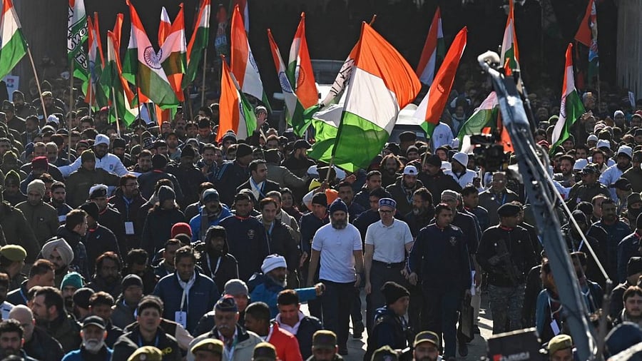 Rahul Gandhi (in white L) and Omar Abdullah (in white R) walk with others during the Bharat Jodo Yatra in Banihal, Kashmir. Credit: PTI File Photo