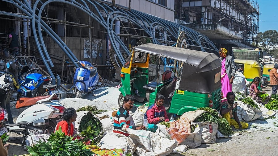 An auto is parked bang in the middle of K R Market, even as redevelopment works are delayed indefinitely. Credit: Special Arrangement