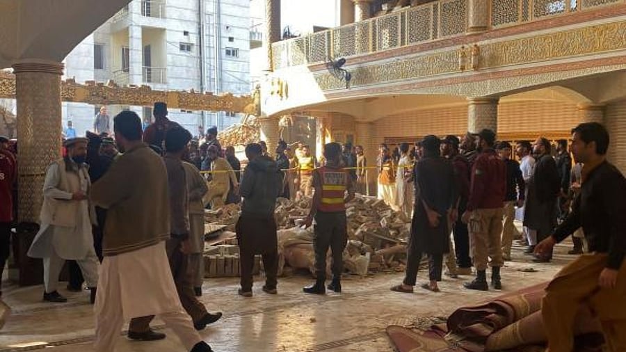 Security officials inspect the site of a mosque blast inside the police headquarters in Peshawar. Credit: AFP Photo