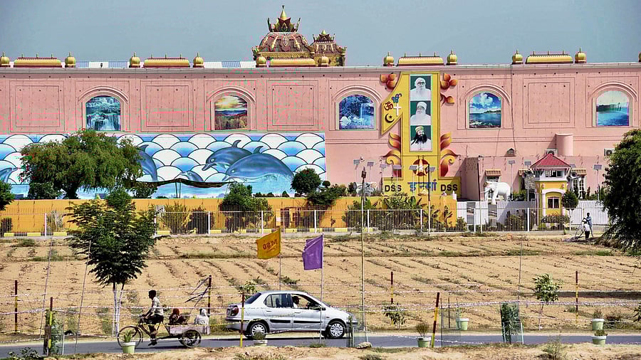 In India, the Machiavellian gurus manipulate the emotions of the masses and play them false by amassing wealth, grabbing public land. Credit: PTI Photo