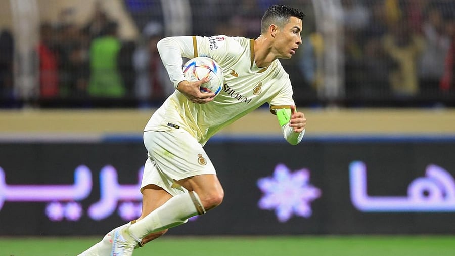 Cristiano Ronaldo runs with the ball after scoring a penalty during the Saudi Pro League football match between Al-Fateh and Al-Nassr. Credit: AFP Photo