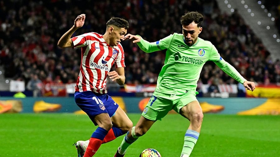 Atletico Madrid's Argentine defender Nahuel Molina vies with Getafe's Moroccan forward Munir El Haddadi(R) during the Spanish league football match between Club Atletico de Madrid and Getafe CF. Credit: AFP Photo