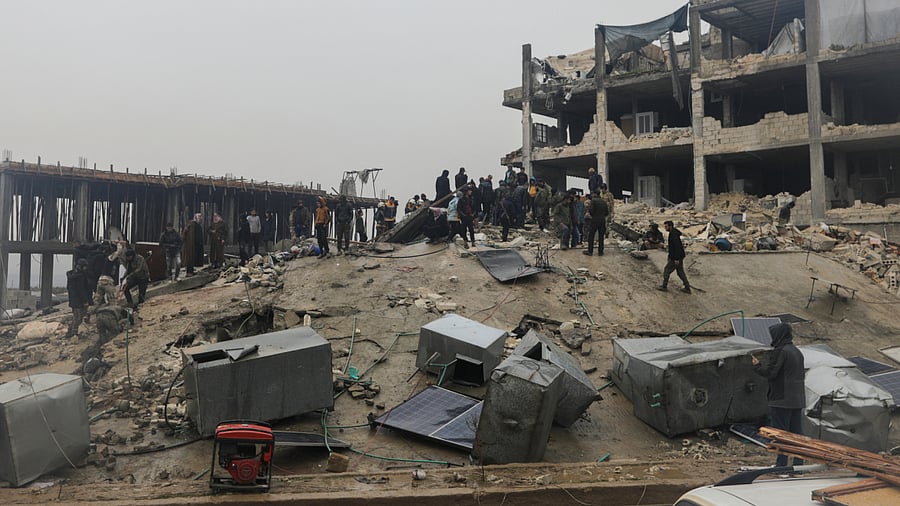 People gather as rescuers search for survivors under the rubble following an earthquake. Credit: Reuters Photo