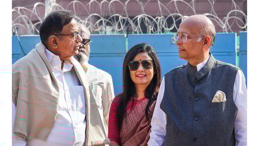 Congress MPs P. Chidambaram and Abhishek Singhvi with TMC MP Mahua Moitra at Parliament House complex. Credit: PTI Photo