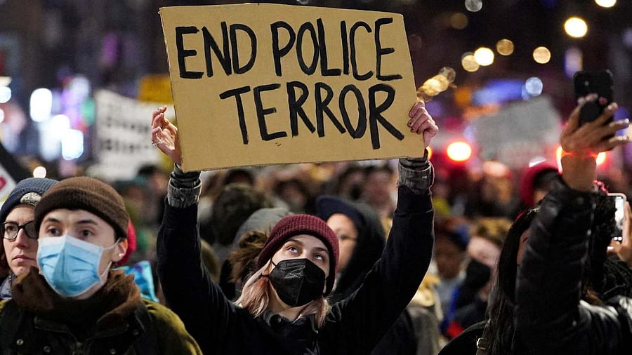 A person holds a sign during a protest following the release of videos showing Memphis police officers beating Tyre Nichols. Credit: Reuters Photo