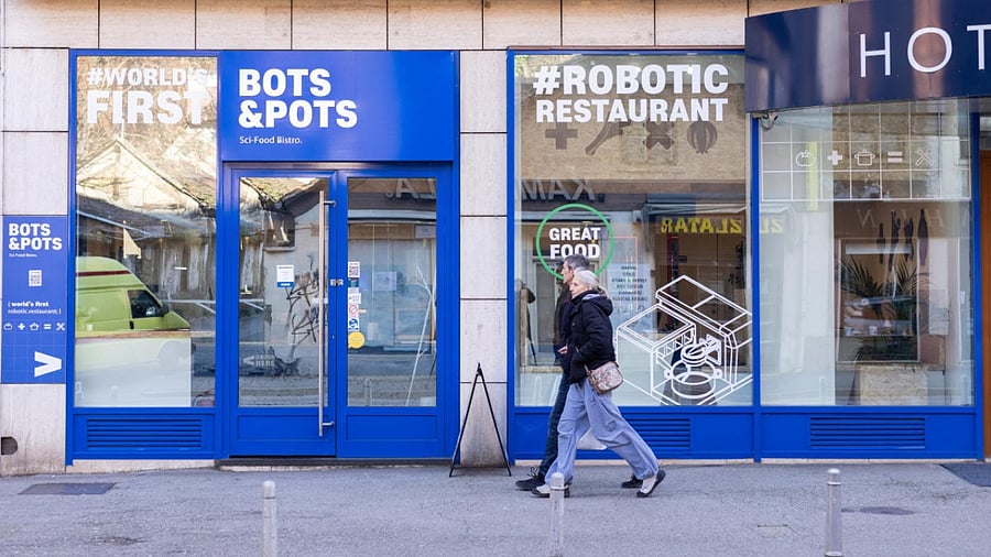 People walk next to robot restaurant Bots & Pots in Zagreb. Credit: Reuters Photo