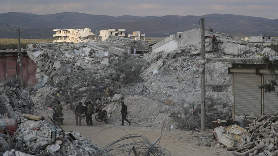 People walk on a street in the aftermath of an earthquake, in rebel-held town of Jandaris, Syria February 11, 2023. Credit: Reuters Photo