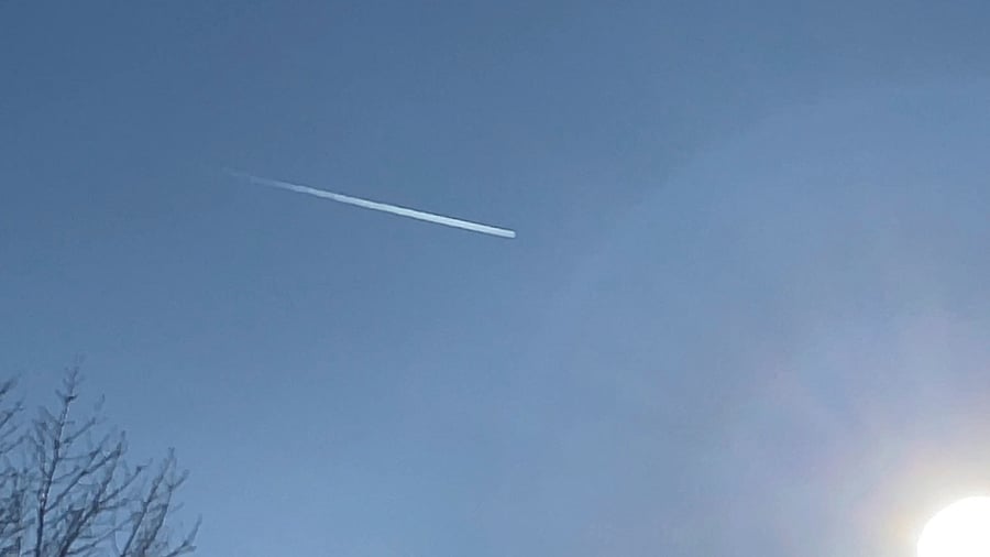 A plane flies over Romulus, Michigan, U.S. February 12, 2023 in this still image obtained from social media video. Credit:  Reuters via SalehTrades