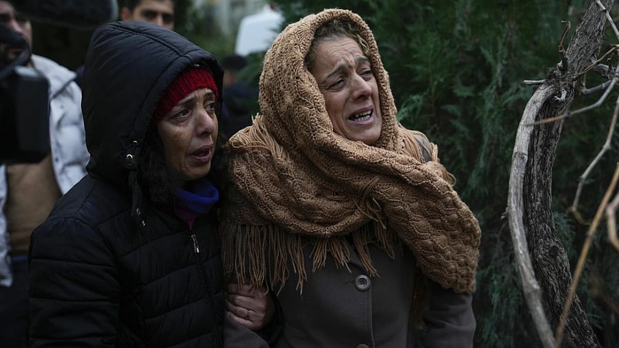 Women cry as they watch while the emergency teams search for people in the rubble of a destroyed building in Adana, Turkey, Monday, Feb. 6, 2023. Credit: AP/PTI Photo